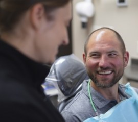 Back of woman relaxing in dental chair