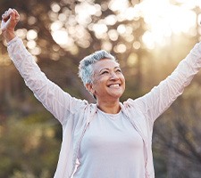 Healthy, happy mature woman standing outside