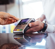 Person using card to pay for treatment