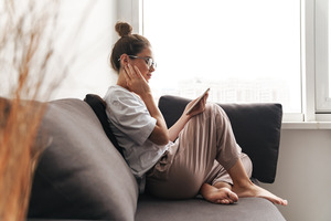 Woman with tooth pain looking at phone