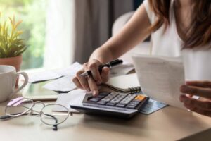 Woman sitting at desk, working on her budget